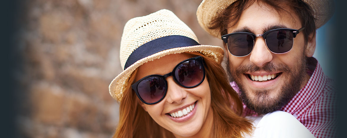slider a young couple wearing sunglasses and nice hats
